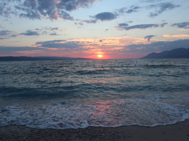 istock Sunset over the sea with waves, Croatia, Dalmatia, Brela 1394918167
