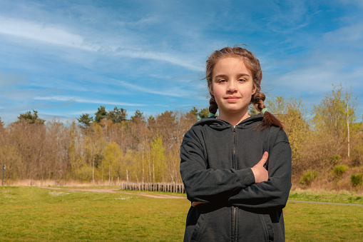 Portrait of a teenager girl on nature background. Copy space.