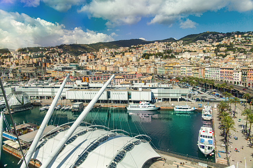 Genoa, panoramic view of the city with the elevated road, the Aquarium and the ancient port (Porto Antico) with the biosphere. Some ferries are moored