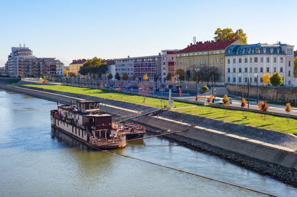 Gyor cirtyscape with ship by Daunbe riverbank in bright sunshine, Hungary