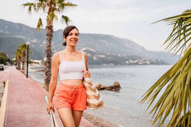 istock Young Woman Walking On The Beach 1394923176