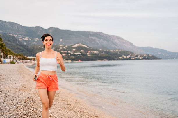 istock Young Woman Running On The Beach 1394923772