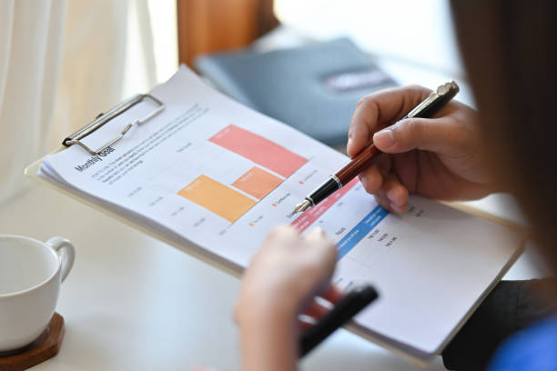 istock Cropped view a businesswoman sitting in the office working on  data, charts and documents on the table, for business and finance  concept. 1394924208