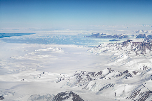blue ice glacier flowing from the Antarctic continent to the sea