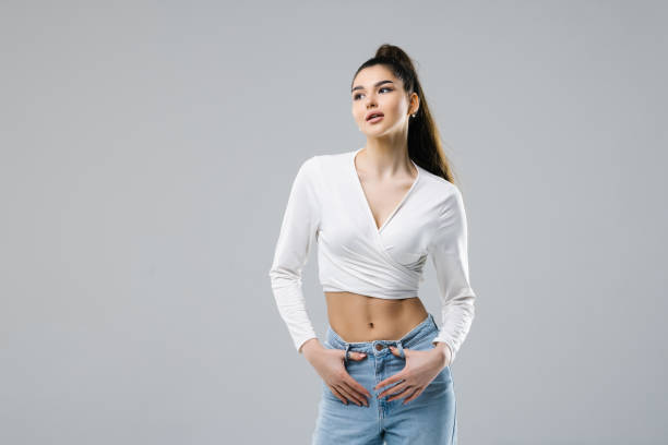 istock Smiling brunette woman posing looking at the camera over white background 1394925310