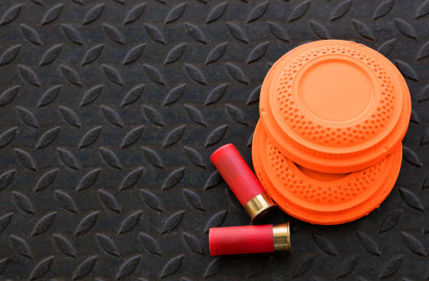 istock Clay shooting target with shotgun bullet on checkered plate background , gun shooting game 1394926593
