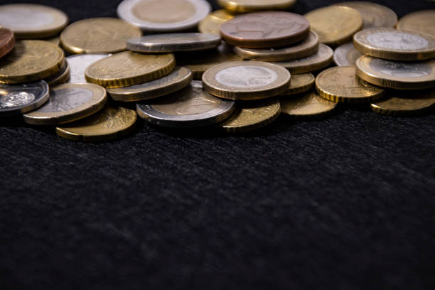 istock European coins on a black cloth as a frame, close-up, copy space. 1394926675
