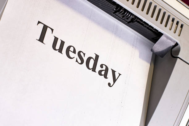 Tuesday, sheet of paper on an office printer with a printed text close-up.