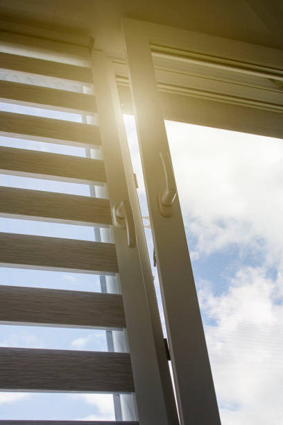 istock a plastic window with a roller blind and a mosquito net against a blue sky 1394927102