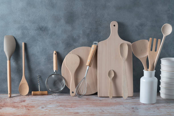 istock Modern kitchen kitchenware in light wood color with ladle, cutting boards and cookware on gray 1394927708