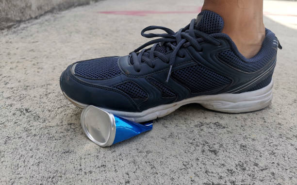istock A man stepped stepping compressed cans on cement ground 1394927853