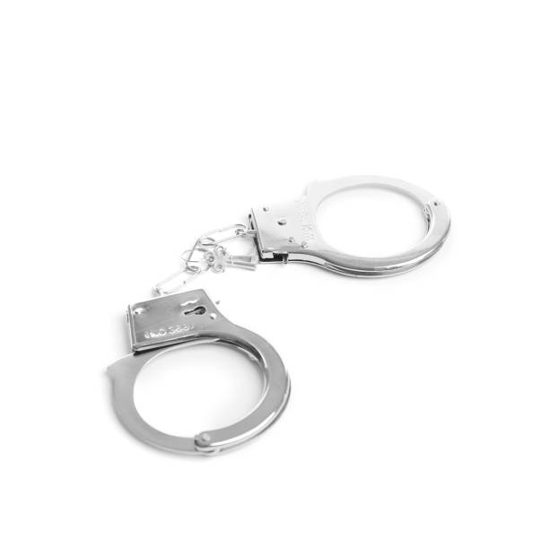 istock Police handcuffs on isolation closeup 1394928877