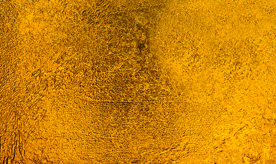 Shiny yellow gold leaf foil surface , can be used as a background