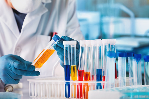 Technician examining test tube in the Medical Research Laboratory. Scientist working with chemical material samples in biotechnology lab