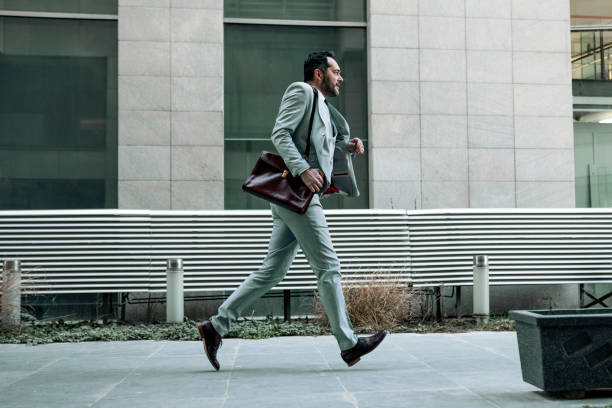 istock Handsome businessman running  to work getting late 1394931170