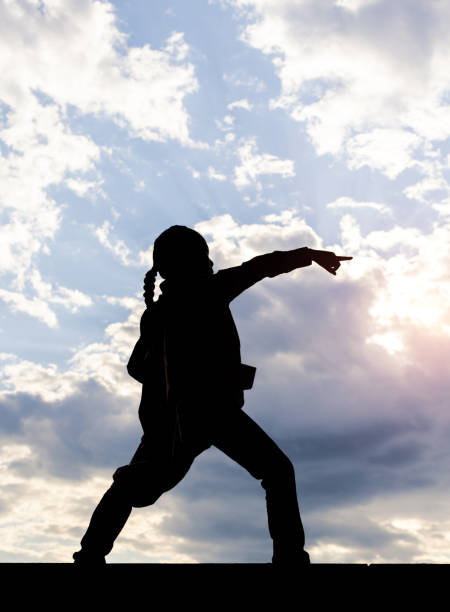 istock Supergirl Silhouette on Sky Background 1394932385
