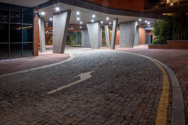istock An empty stone road leads to a building in the night 1394932425