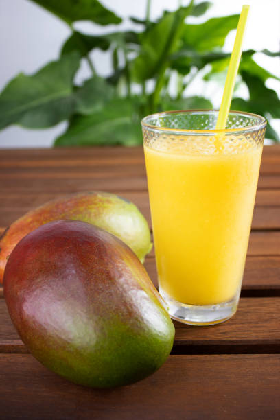 istock smoothie, granita or mango milkshake on wood 1394934613