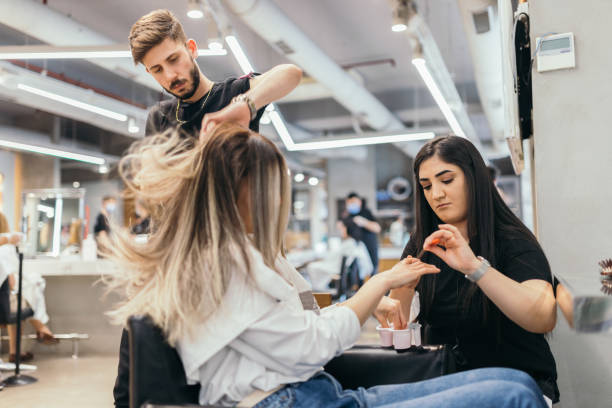 Young woman  on manicure treatment at beauty salon Young woman  on manicure treatment at beauty salon blow drying stock pictures, royalty-free photos & images