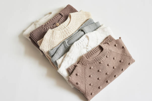 istock Stack of knitted clothes. Baby clothes. Needlework, hobby, knitting, handwork 1394938976