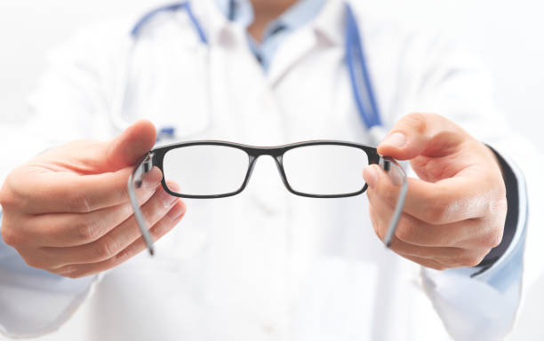 istock Optometrist holds glasses to try on 1394939131
