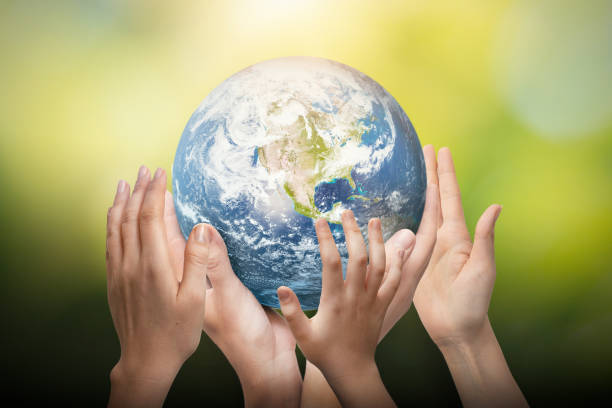 istock Earth globe in family hands. World environment day 1394939144