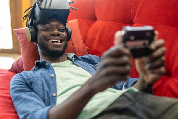 istock African american young man enjoying games and hi-tech, generation z boy using joypad and virtual reality visor for playing in the cyberspace 1394939172