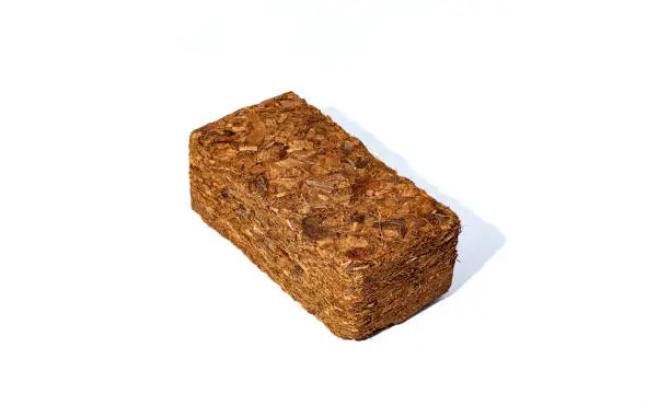 Photo of Block of Coconut Coir Husk Fiber isolated on white background.