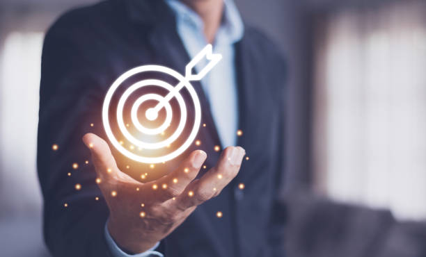 istock Man holding virtual dartboard and arrow with copy space for setup business objective target concept. 1394939407