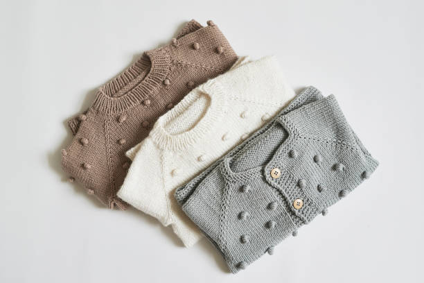 istock Stack of knitted clothes. Baby clothes. Needlework, hobby, knitting, handwork 1394940041