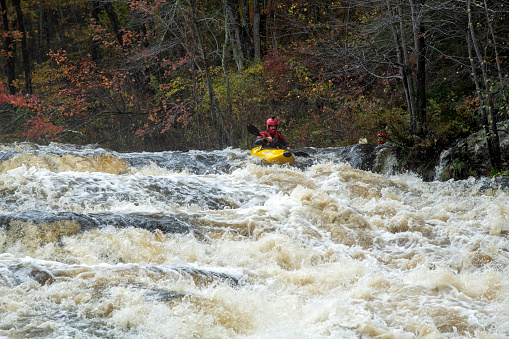 Shohola, USA - October 30, 2021. Men kayaking at Shohola Falls, Shohola, Pennsylvania, USA