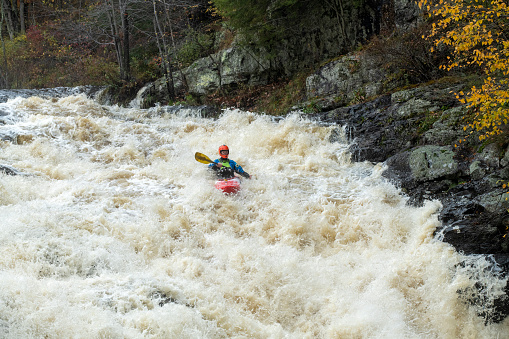 Shohola, USA - October 30, 2021. A man kayaking at Shohola Falls, Shohola, Pennsylvania, USA
