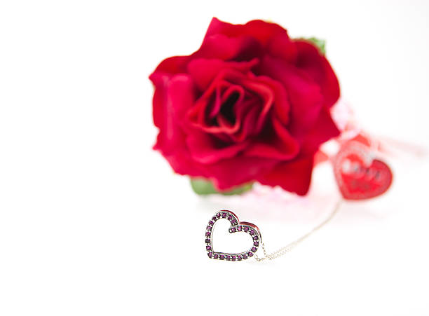 Pave` diamonds fill this heart pendant cluster.