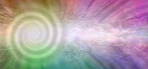 Spiralling rotating stream of light  flowing against a rainbow coloured ethereal wispy energy field background with copy space