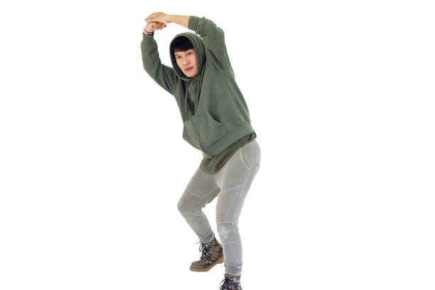 Smiling Asian young professional dancer man is break dancing by isolataed on white background in studio. Education and sport for hobbies concept.