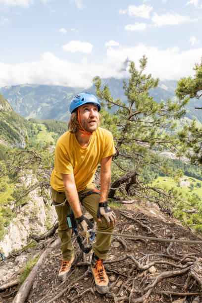 istock Man on Via Ferrata climbing up, summer activities concept 1394942602