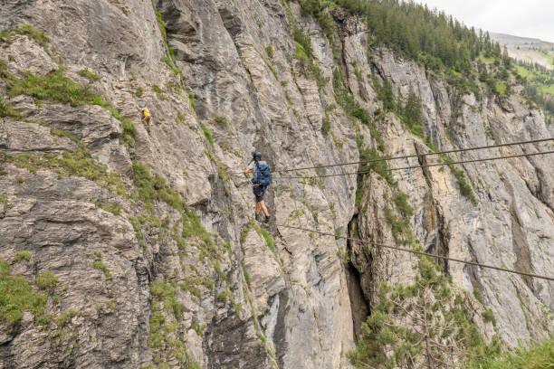 istock Man on Via Ferrata crossing monkey bridge 1394943594