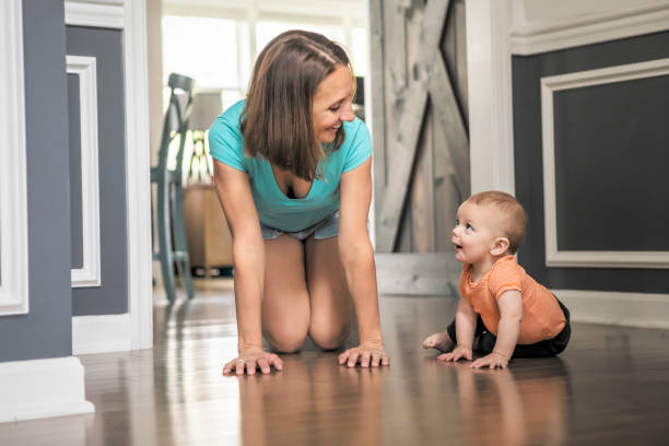 istock Mother Teaching 8 Month Old Baby Boy How to Crawl 1394943616