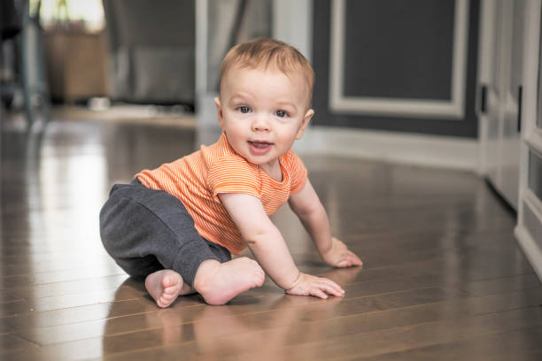 istock Active Eight Month Old Baby Boy Crawling on Floor 1394943749