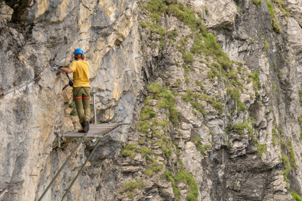 istock Man on Via Ferrata climbing up, summer activities concept 1394943787