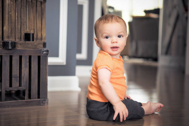 istock Eight Month Old Baby Boy Sitting on Floor 1394943983