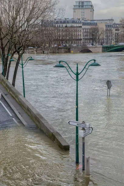 A flood on the River Seine viewed from quai des Célestins, in the background is pont de Sully and boulevard Henri IV.