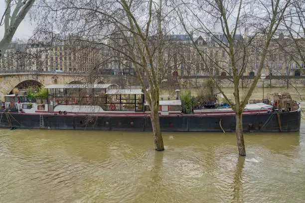 La Péniche Marcounet in front of île Saint-Louis seen from quai de l’Hôtel-de-Ville. Dozens of restaurant boats are obliged to close for three or four weeks when the River Seine floods as it did at the end of January 2018, rising 18 feet above its usual level.