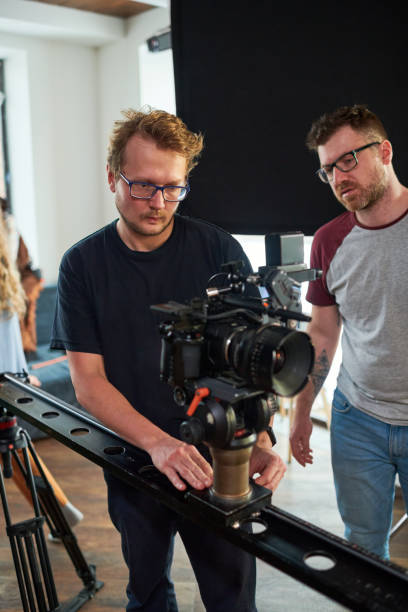 istock Young professional videographer moving video camera along slider 1394944126