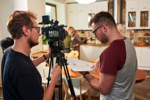 istock Young operator or cameraman consulting with his assistant or colleague 1394944129