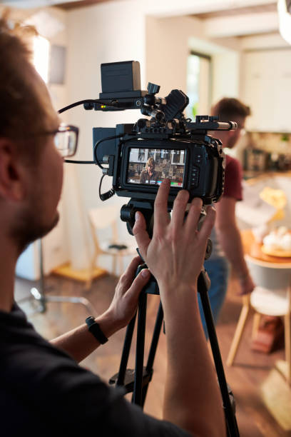 istock Contemeporary videographer or cameraman adjusting video camera options 1394944139