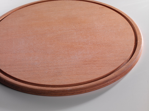 Selective focus Wooden pizza plate with white background