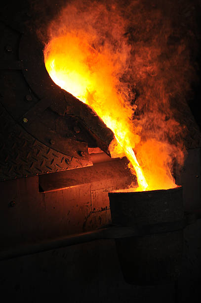 Foundry with molten metal pouring stock photo