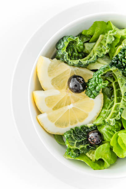 Fresh spring salad with kale, lettuce, blueberries and lemon