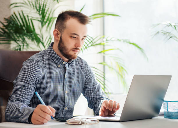 istock Businessman working on his laptop in an office 1394947432